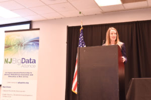 Katie Comanto speaking at podium